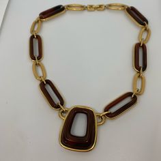 Modernist Necklace Vintage From The 1970s. 100% Authentic Givenchy. Raised Resin Design Over Brushed Gold Tone Links. 16.5 Inches Long. Resin Has The Look Of Tortoise Shell. Signature Double G Logo Clasp. Signed At The Reverse Of The Pendant Givenchy Paris New York 1976. Excellent Condition. Formal Gold Lucite Jewelry, Retro Formal Jewelry With Chain Detail, Retro Yellow Gold Necklace For Formal Occasions, Retro Chain Necklace For Formal Occasions, Retro Formal Chain Necklace, Vintage Brown Necklace For Formal Occasions, Formal Retro Chain Necklace, Givenchy Jewelry, Givenchy Paris