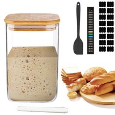 a glass jar filled with food next to a cutting board and utensils on a white surface