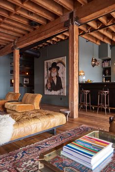 a living room filled with furniture and a painting on the wall