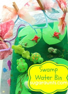 a close up of a cake on a table with flowers in the background and text swamp water bin