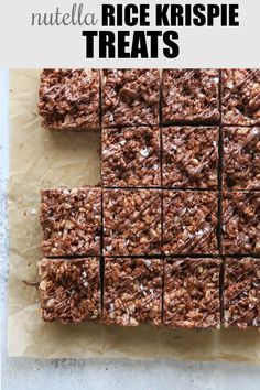 chocolate brownies cut into squares on top of parchment paper