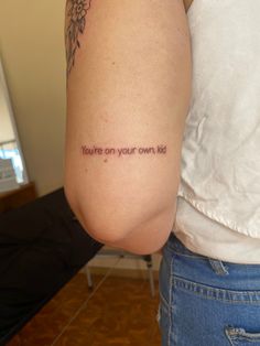 a woman with a tattoo saying you're on your own