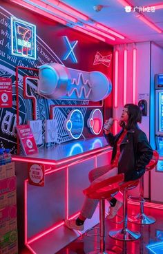 a woman sitting at a bar with neon lights