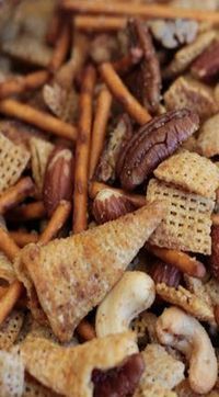 nuts and crackers are mixed together to make a cheesy snack for lunch