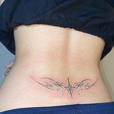 a woman's lower back tattoo with birds on it