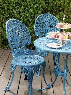 an outdoor table and chairs on a wooden deck