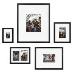 four black and white pictures hanging on the wall with one photo in front of them