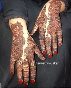 two hands with henna designs on them