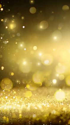 an abstract gold background with sparkling lights