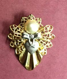 "Guardian Angel Pin, Angel Pin Brooch,Angel Jewelry This pretty guardian angel pin has a contrasting heart bow that says \"I love you.\" Available in bright silver or gold with a contrasting bow. Pearl head Size: 1 1/4\"x 1\" Gift Boxed #127" Gold Brooches For Valentine's Day Party, Gold Heart-shaped Brooches For Gifts, Heart-shaped Gold Pins For Gifts, Angel Pin, Vintage Jewellery Rings, Angel Jewelry, Angel Necklace, Get Well Gifts, Guardian Angels