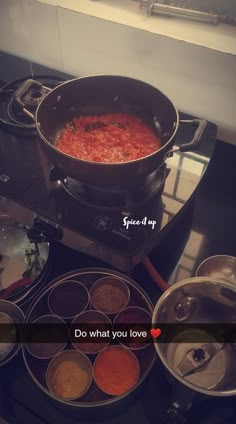 a stove top filled with lots of different types of cooking utensils and sauces