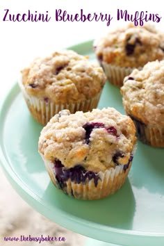 four blueberry muffins on a green plate