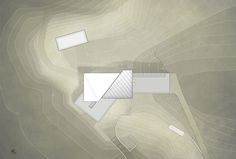 an aerial view of a building in the middle of a desert with white lines on it