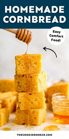 homemade cornbreads stacked on top of each other with honey being drizzled over them