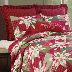 a red and green christmas quilted bed set with merry lettering on the comforter