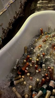 a bath tub filled with lots of bottles and ice