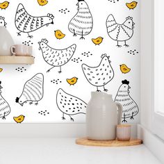 the wallpaper in this kitchen is painted with yellow and black hens on it