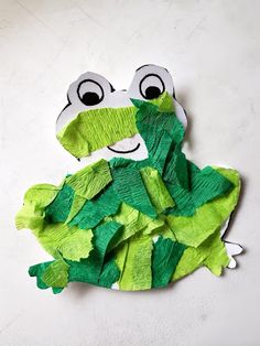 a frog made out of paper sitting on top of a table