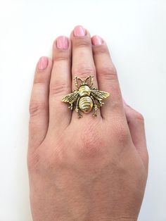 "This beautiful adjustable bee ring is perfect for a summer woodland look. Very pretty vintage inspired. Sweet as can bee! 24k antiqued gold plated brass bee attached to an adjustable ring. Highly detailed, rustic, woodland accessory perfect for any day. Ring adjusts from size 7 - 9 and a half. Bumble Bee measures 1.25\" wide x 1.25\" long. (34mm wide x 34mm long). Your order will be shipped in two business days. Every piece is handcrafted in my home jewelry studio and is one of a kind. All of m Bumble Bee Ring, Sweet As Can Bee, Gift Box For Men, Bee Ring, Jewelry Studio, Ring Boho, Queen Bee, Favorite Rings, Queen Bees