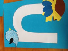 the letter n is made with construction paper and cut out birds sitting on top of it