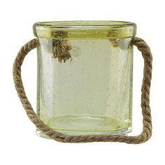 a glass jar with rope around it on a white background