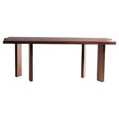 a long wooden table sitting on top of a white floor