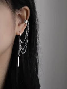 a close up of a person wearing some kind of earring with chains attached to it