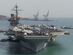 an aircraft carrier is docked in the water