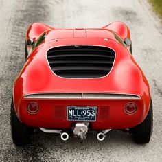 a red sports car is parked on the road