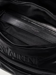 SAINT LAURENT's belt bag is embroidered with a tonal moniker in its recognisable serif font. Made in Italy from black glossed-leather and canvas, it has a spacious interior for your phone, AirPods and cardholder, plus two external pockets to keep smaller essentials organised. Luxury Belt Bag Pouch, Luxury Pouch-shaped Belt Bag, Luxury Travel Belt Bag With Dust Bag Included, Leather Shoulder Bag With Embroidered Logo For Travel, Black Leather Bag With Embroidered Logo, Luxury Formal Belt Bag, Black Leather Shoulder Bag With Embroidered Logo, Luxury Leather Shoulder Bag With Embroidered Logo, Luxury Leather Bags With Embroidered Logo