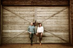 two people standing in front of a garage door