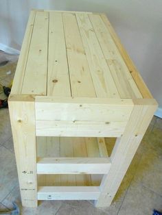 a wooden table sitting on top of a tiled floor