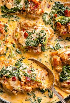 a skillet filled with chicken, spinach and cheese