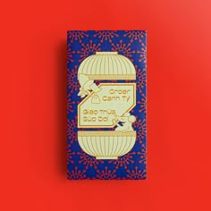 a blue and red book with an image of a birdcage on it