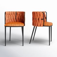 two orange chairs sitting next to each other