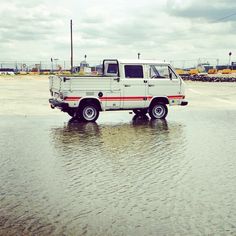 a white truck is parked in the water