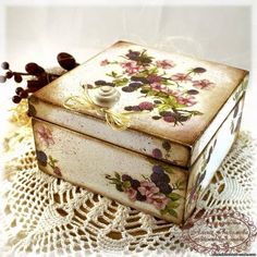 a decorative box sitting on top of a doily