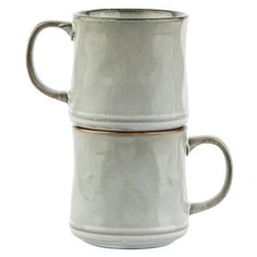 two white mugs sitting side by side on top of each other, one with gold rim