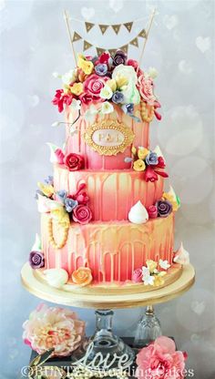 a three tiered cake with flowers on top