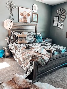 a bed room with a neatly made bed and pictures on the wall