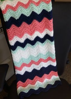 a crocheted blanket sitting on top of a chair