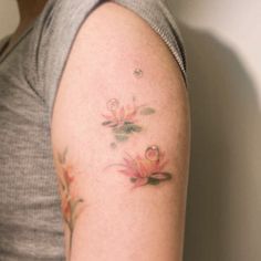 a woman with a flower tattoo on her arm