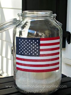 a glass jar with an american flag painted on it