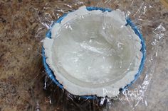 a bowl is wrapped in plastic and sitting on the counter top, ready to be used