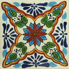 a decorative tile with blue and orange flowers on the bottom, surrounded by green leaves