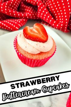 strawberry cupcakes with cream cheese frosting and strawberries in the middle on a white plate