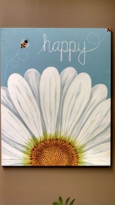 a painting of a white daisy with a bee on it and the words happy written in cursive writing