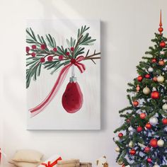 a christmas tree with presents under it and a painting hanging on the wall above it