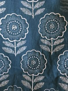 a blue and white fabric with flowers on it