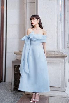 Possesses a basic dress form that helps to flatter the curves of the body A very simple but extremely poetic design with a drop shoulder design, knotted to create a lovely bowtie. Pastel blue tones express pure, gentle beauty, bringing a sense of peace. Product Details - Product type: Midi Dress- Material: Organza, Taffeta- Draped off-shoulder - Big bowtie at the shoulder - Fitted waist - A-line skirt - Length: 115cm Size & Fit - Model wears size: S- Model measurement: 170cm, 86-62-88 Care Instr Beautiful Dps, Bowtie Dress, Bow Tie Dress, Mean Blvd, Pastel Dress, Bow Dress, Basic Dress, Modest Fashion Outfits, Shoulder Design